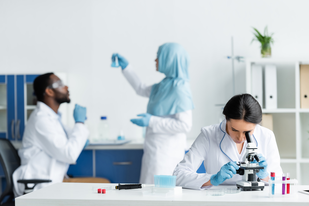 scientist-looking-through-microscope